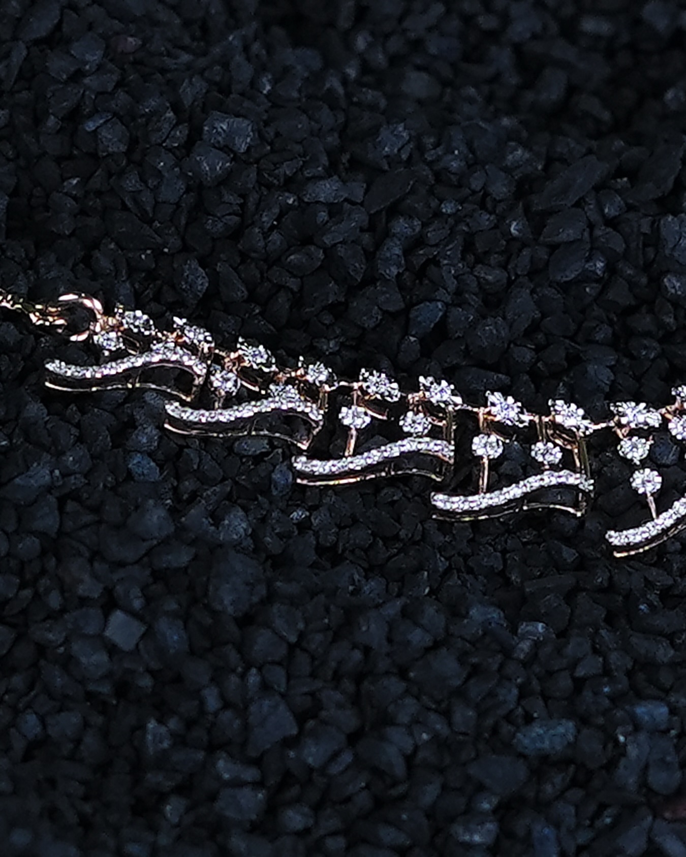 MIORAH floral diamond bracelet on a black gravel display